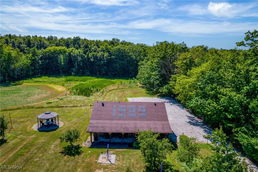 View of subject property featuring a forest