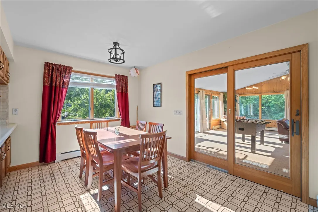 Dining room with a baseboard radiator and light floors