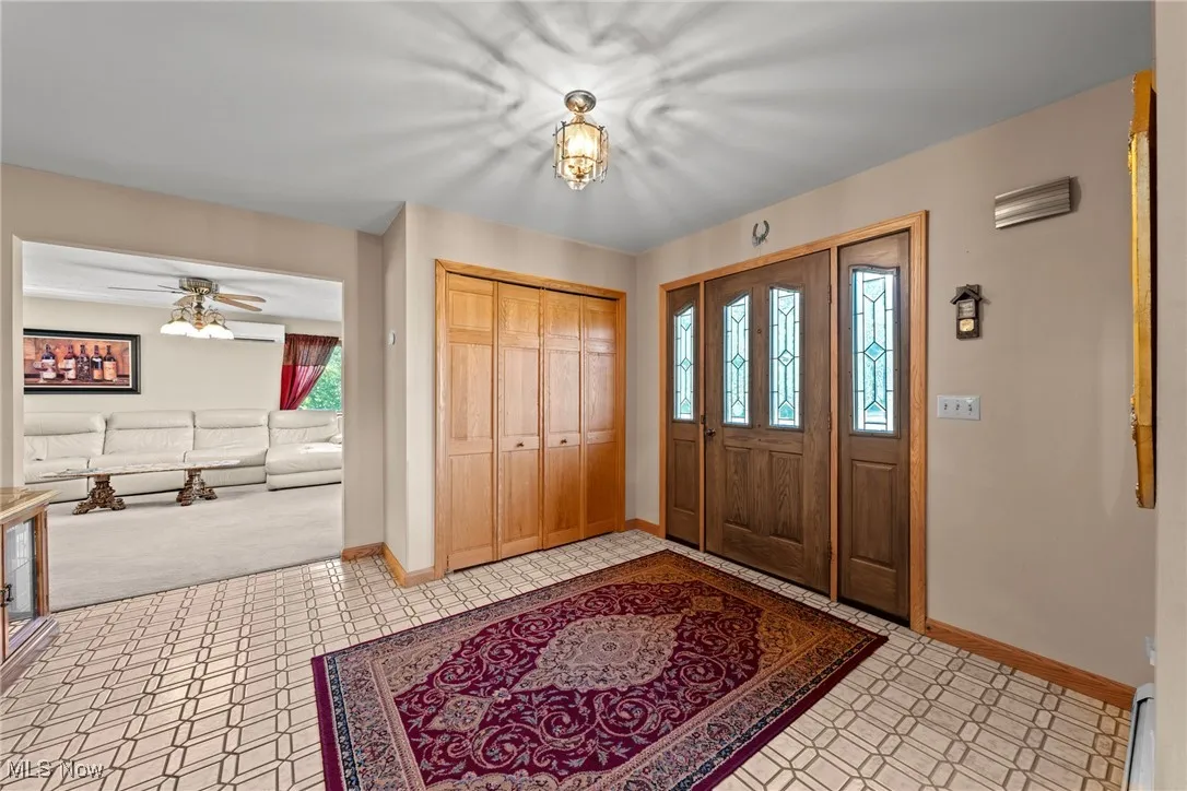 Foyer featuring a baseboard heating unit and a ceiling fan