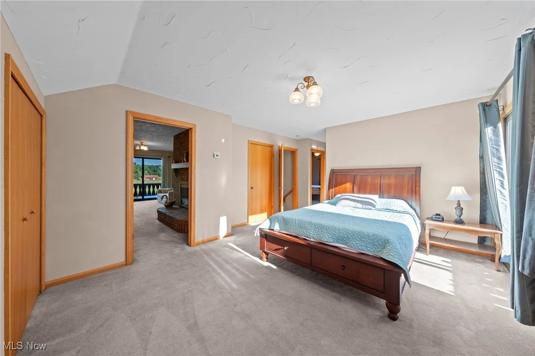 Bedroom featuring light carpet and baseboards