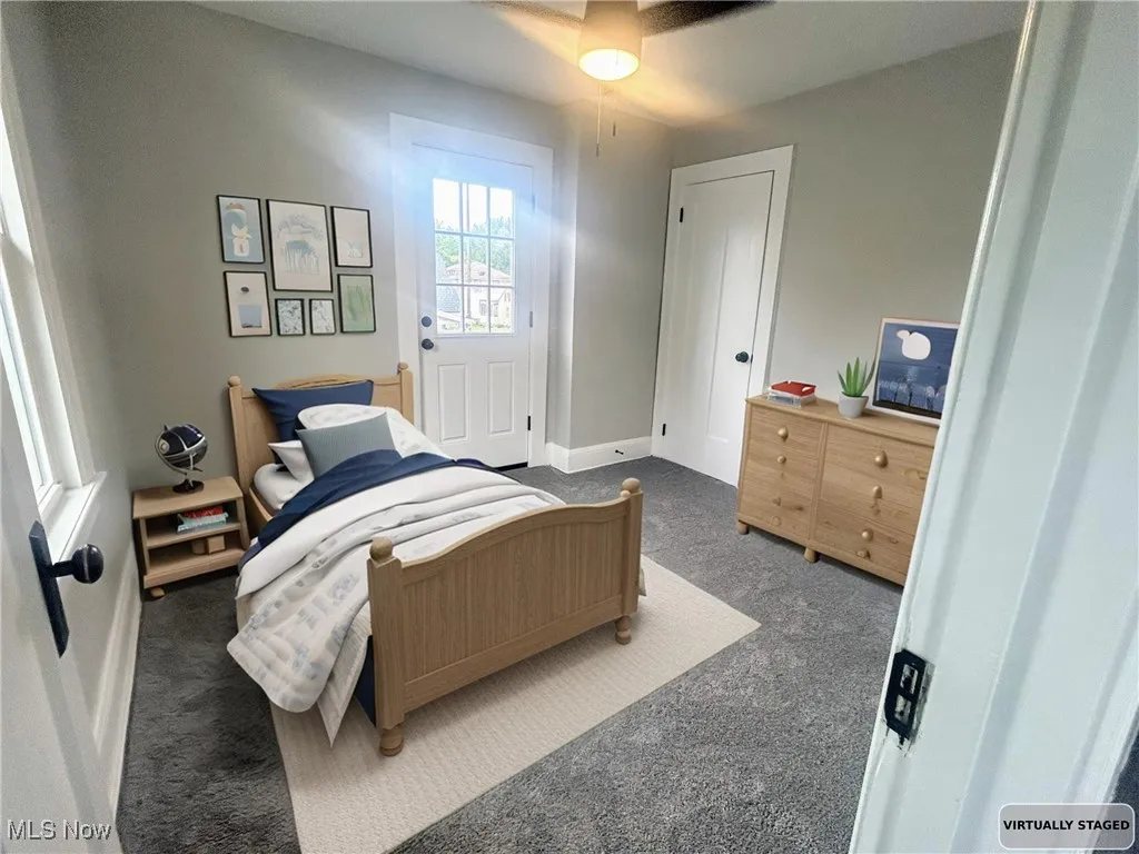 Carpeted bedroom with baseboards and a ceiling fan