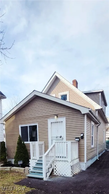 Rear view of property with a chimney