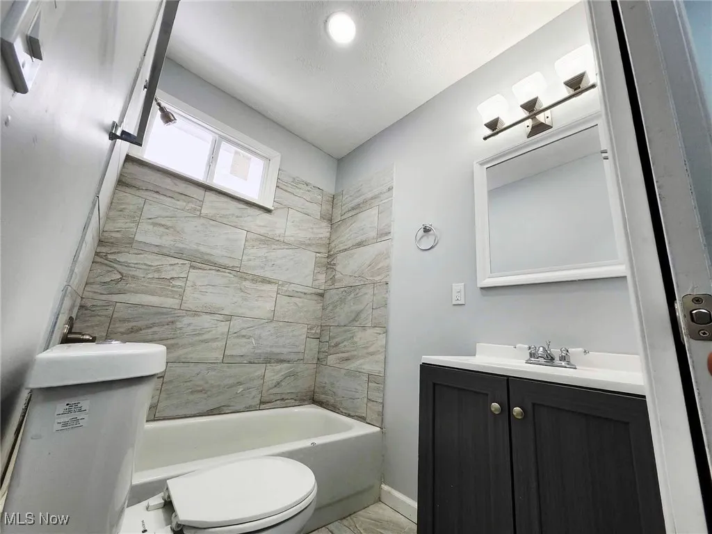 Bathroom featuring vanity and tub / shower combination