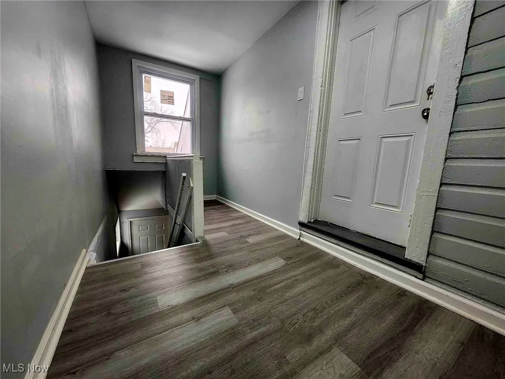 Foyer entrance with wood finished floors and baseboards