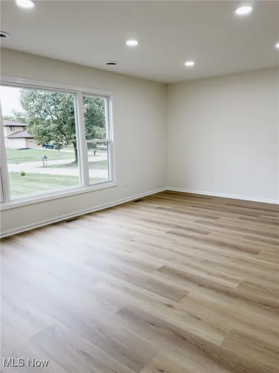 Unfurnished room with recessed lighting and light wood-type flooring