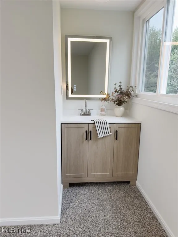 Bathroom with vanity and baseboards