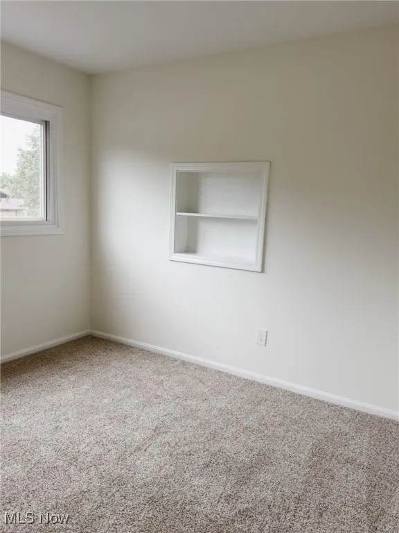 Spare room with carpet floors and baseboards