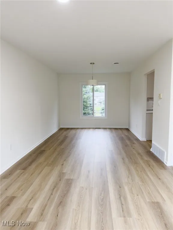 Empty room featuring light wood-type flooring
