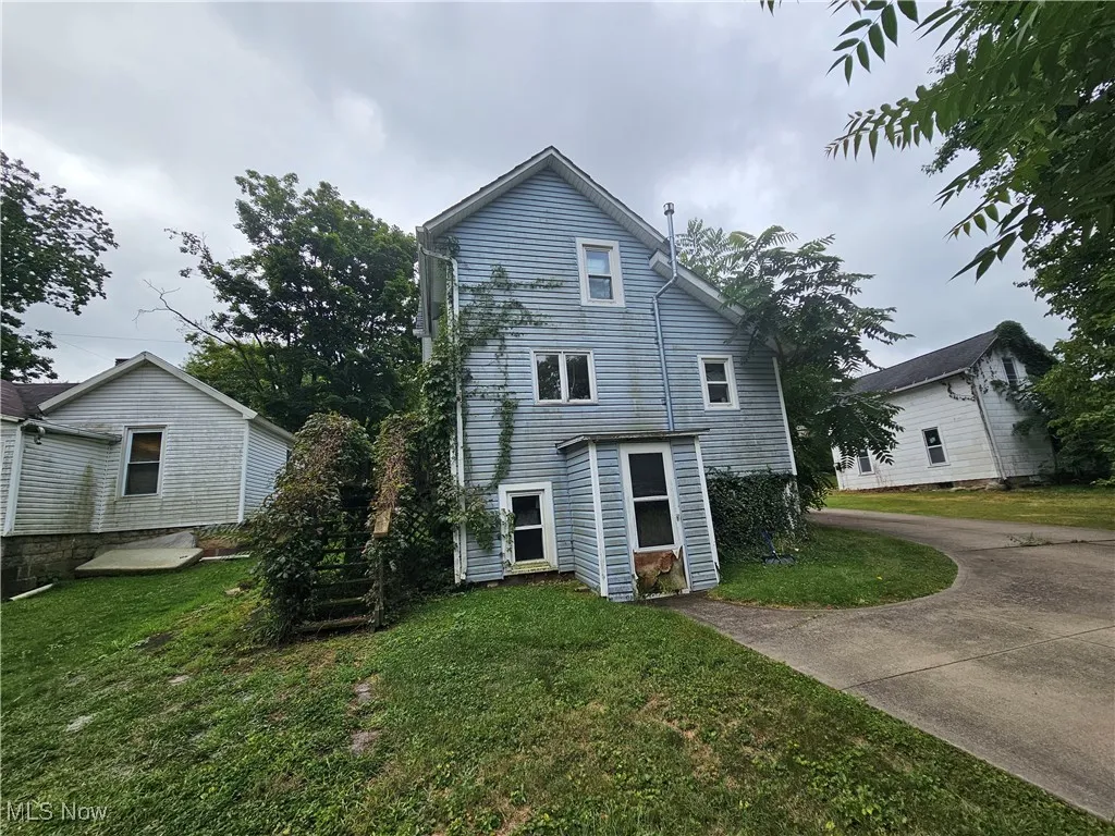 Back of house with a yard