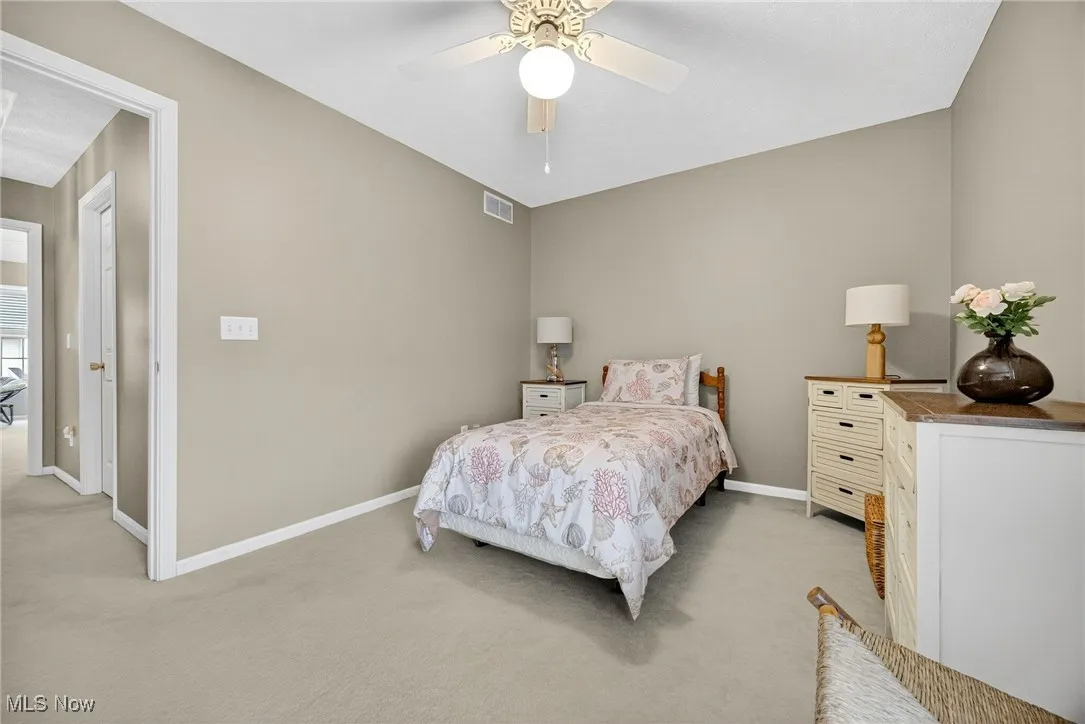Carpeted bedroom with baseboards and ceiling fan