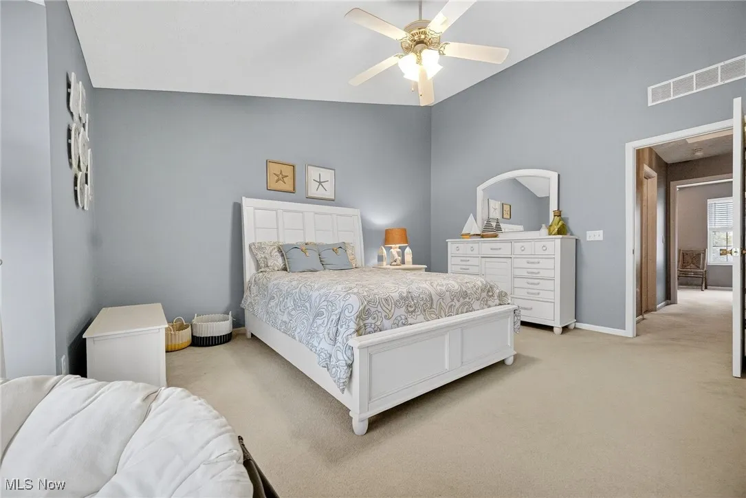 Carpeted bedroom featuring baseboards and a ceiling fan