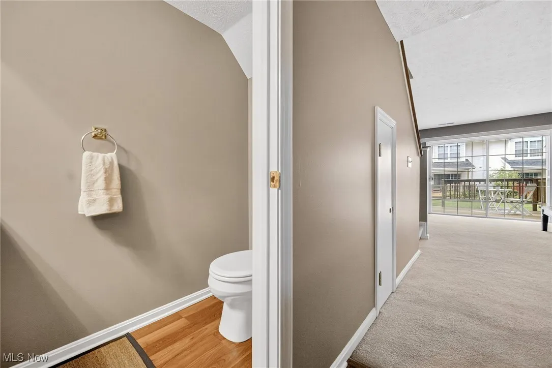 Bathroom with a textured ceiling and light wood-style flooring