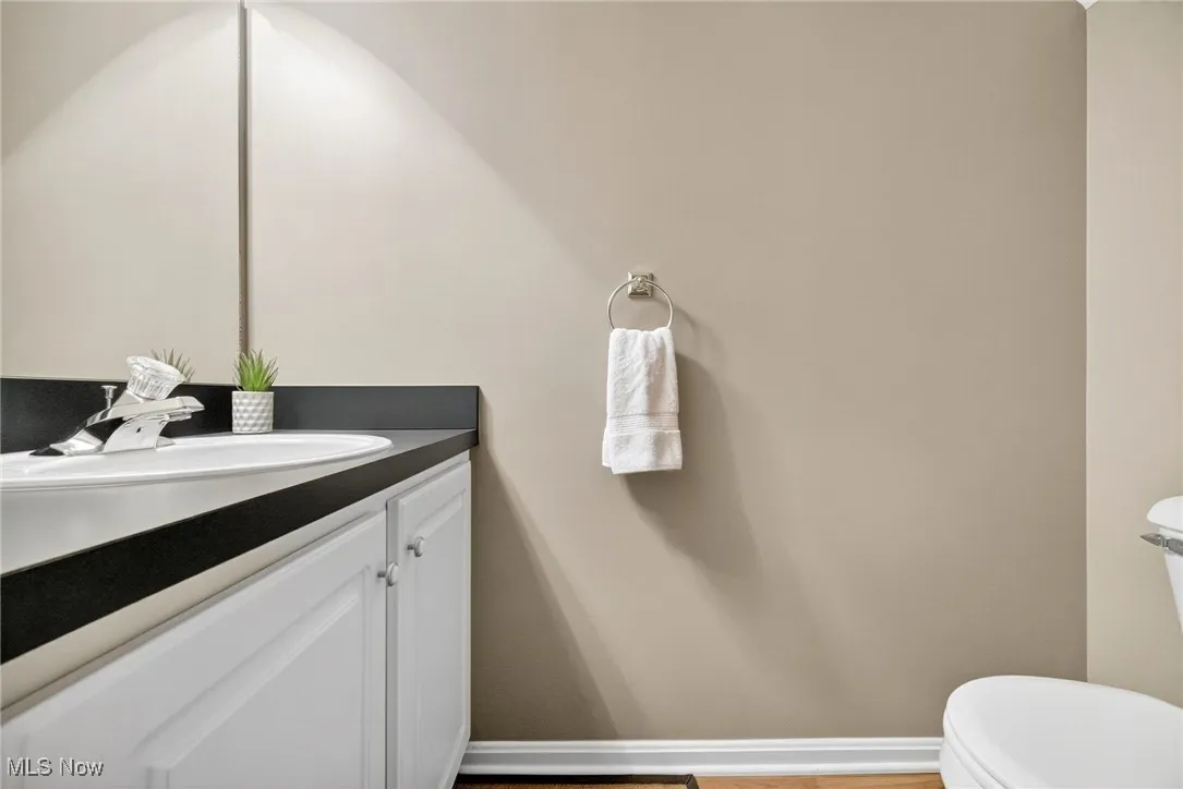 Half bath featuring vanity and light wood-type flooring