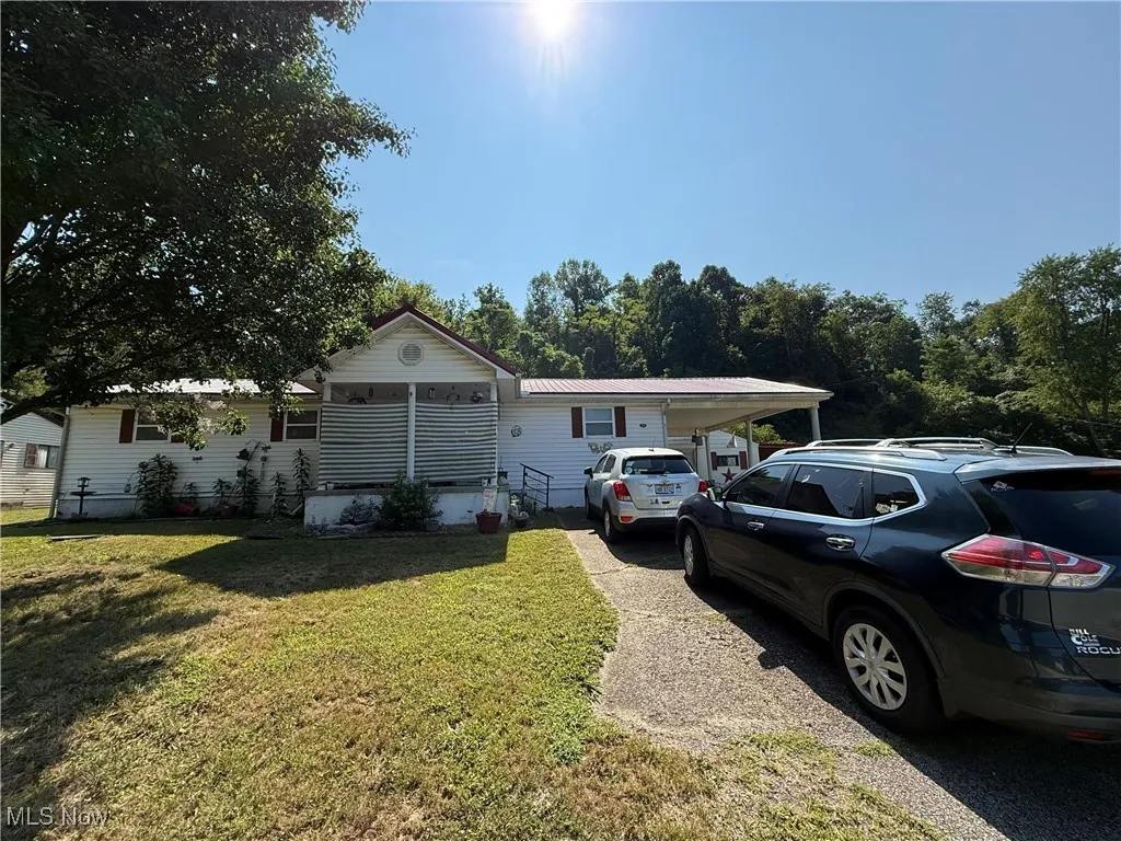 View of front of property with a front yard and a metal roof