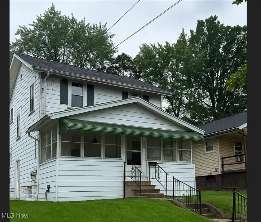 View of front of home featuring a front yard and a porch