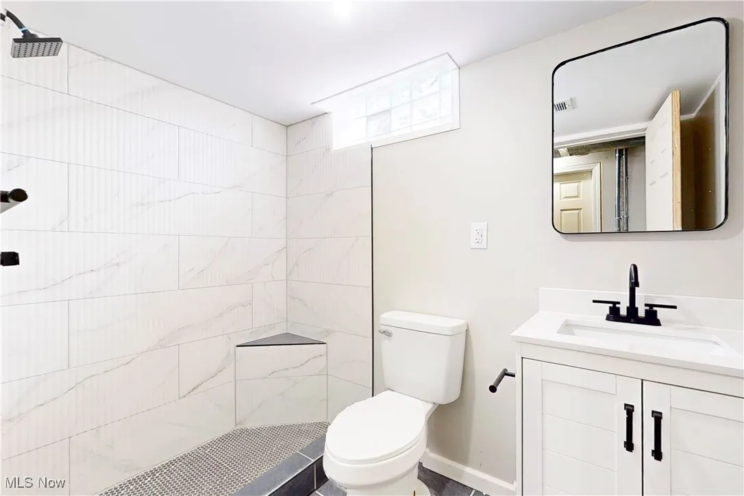 Full bath featuring vanity and a shower stall