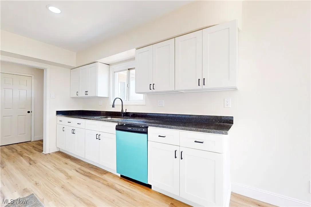 Kitchen with white cabinets, dishwasher, light wood-style flooring, and recessed lighting