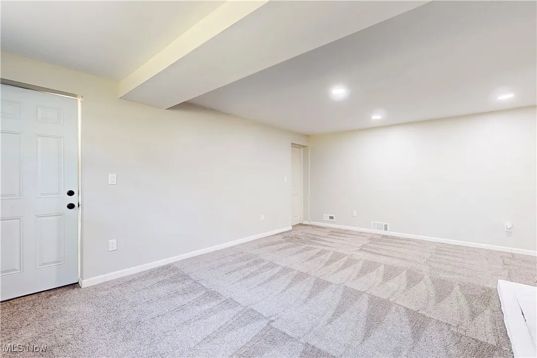 Basement featuring light carpet and recessed lighting