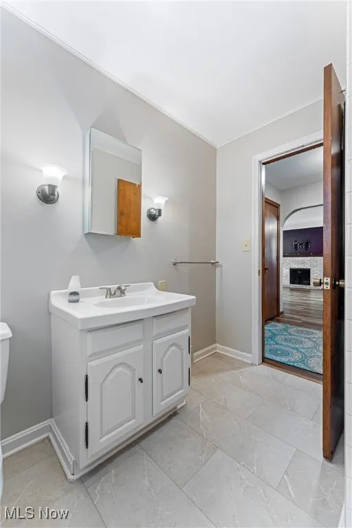 Half bathroom featuring vanity and toilet