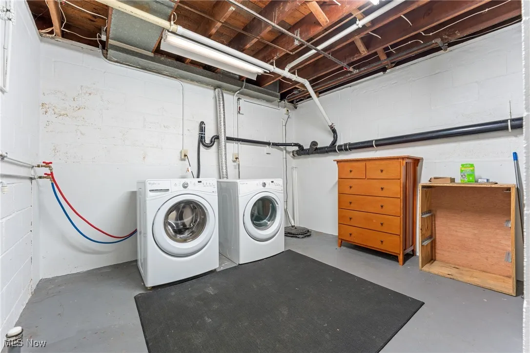 Washroom featuring washing machine and dryer