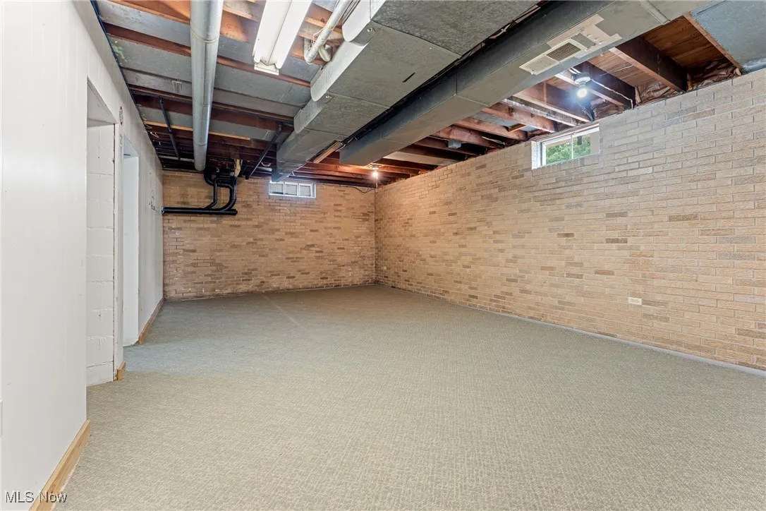 Below grade extra living space with plenty of natural light and light carpet