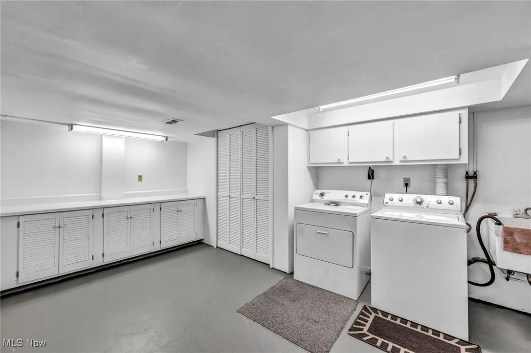 Laundry room featuring cabinet space and independent washer and dryer