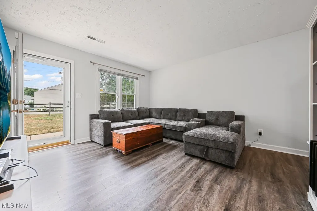 Living room featuring wood finished floors and a textured ceiling
