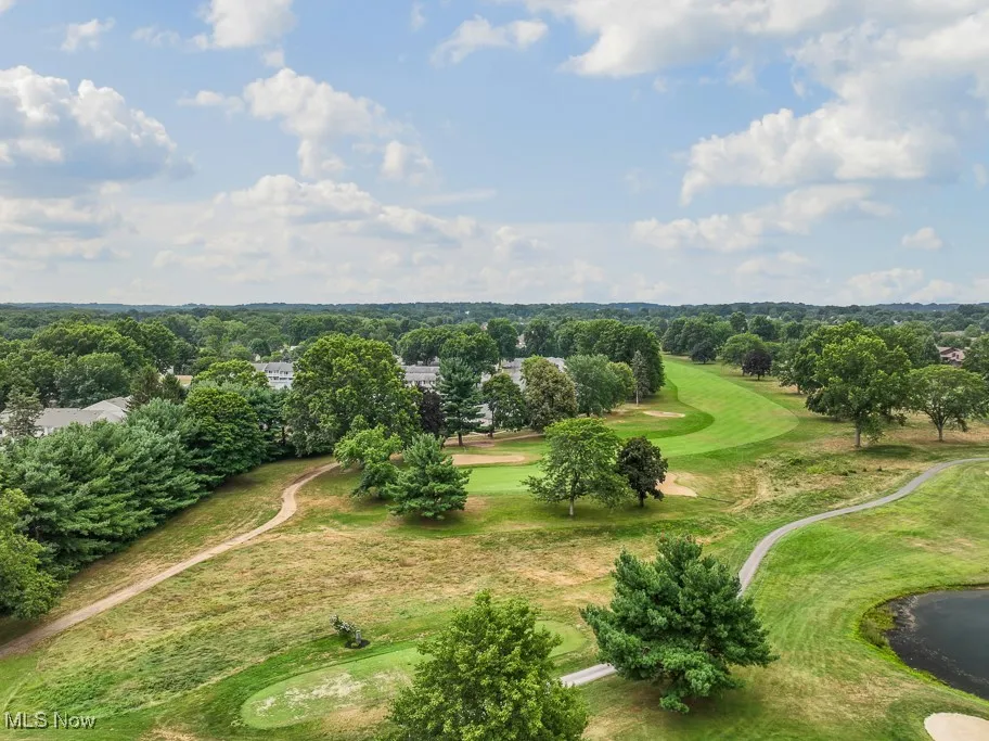 Drone / aerial view of a local golf course and a tree filled landscape