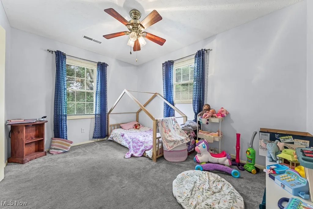 Bedroom featuring carpet and a ceiling fan
