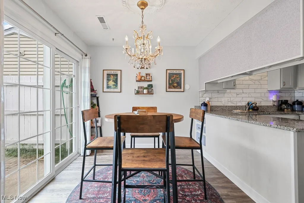 Dining area with a chandelier and dark wood finished floors
