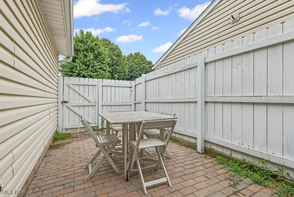 View of patio / terrace featuring outdoor dining area and a gate
