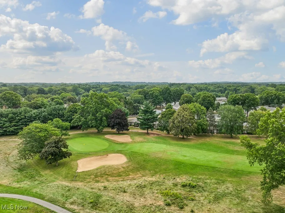 View of home's community featuring view of golf course and view of wooded area