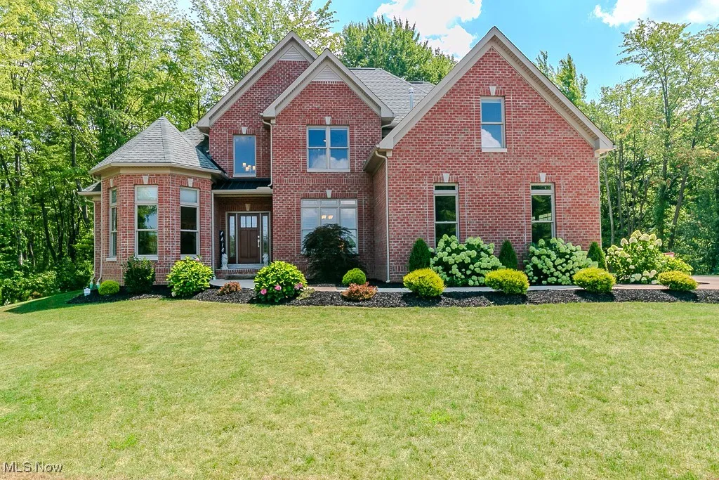 View of front of property with brick siding and a front yard