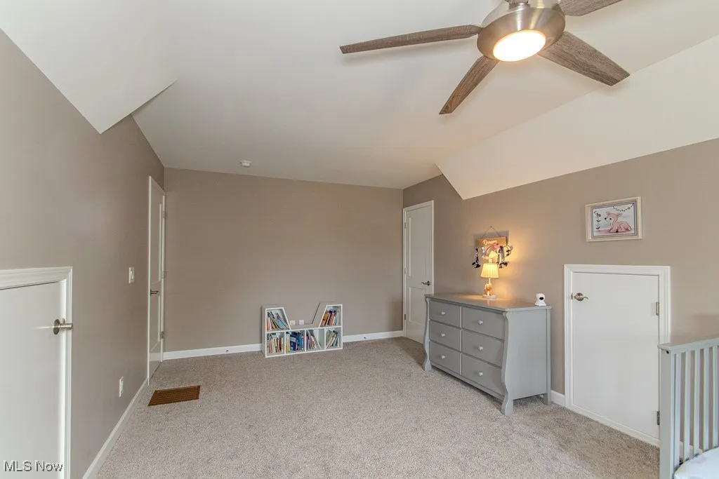 Bedroom with light carpet and ceiling fan