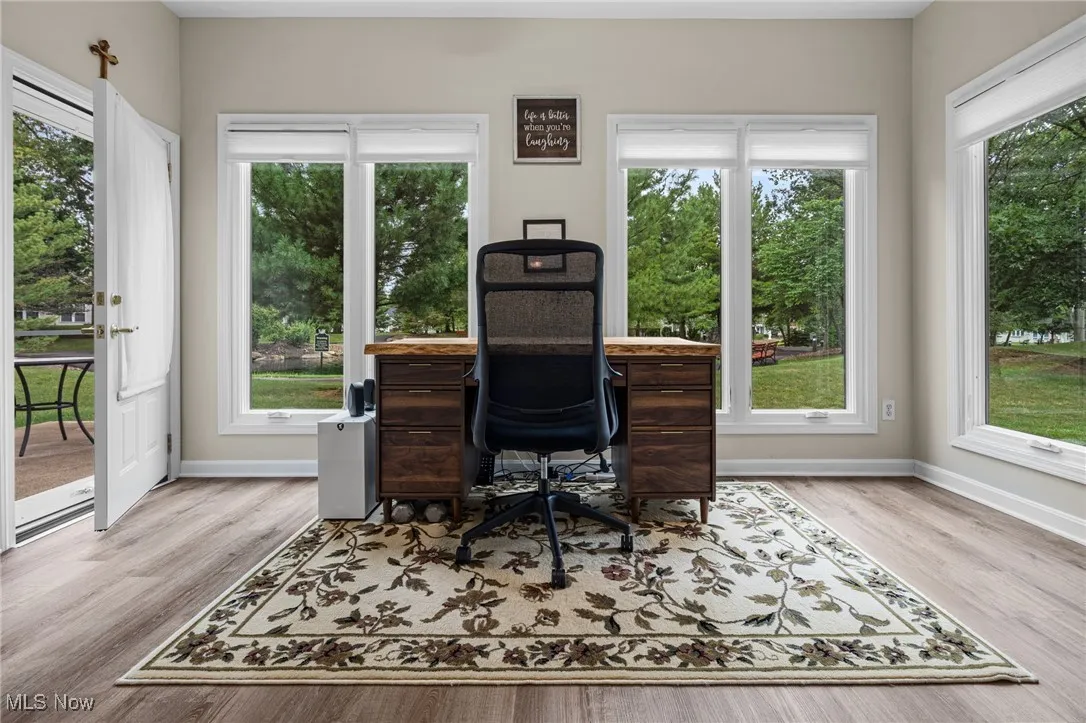 Office area with light wood-style flooring and healthy amount of natural light