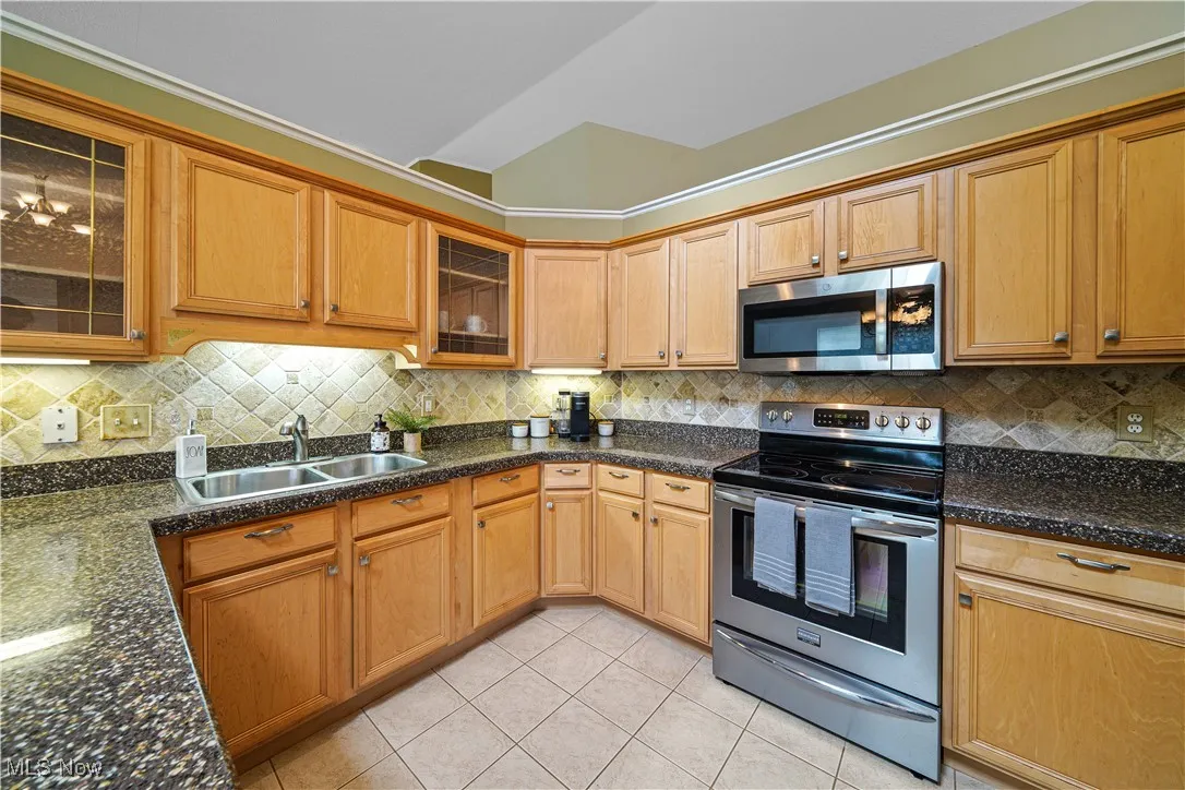 Spacious eat in kitchen with undermount lights and outlets above the cabinets and granite overlay counter tops.