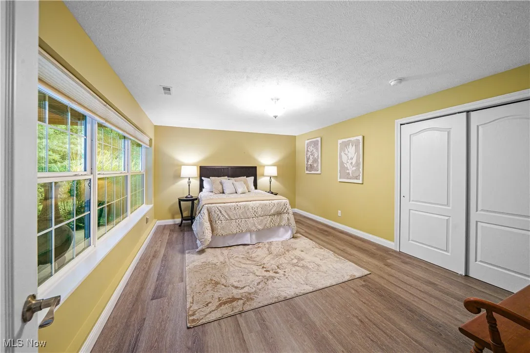 bedroom with views of the wooded back yard.