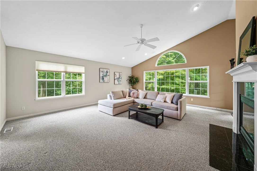 This massive great room has beautiful views of the wooded yard.  Gas fireplace with built in shelves and vaulted ceilings.