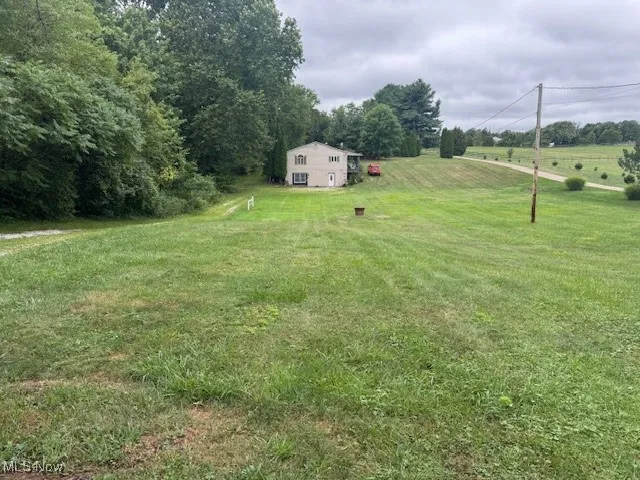 View of green lawn featuring a view of rural / pastoral area