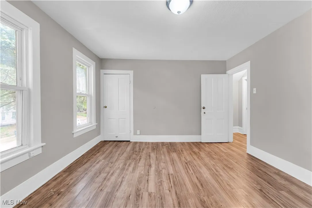 Unfurnished bedroom with light wood-type flooring and baseboards