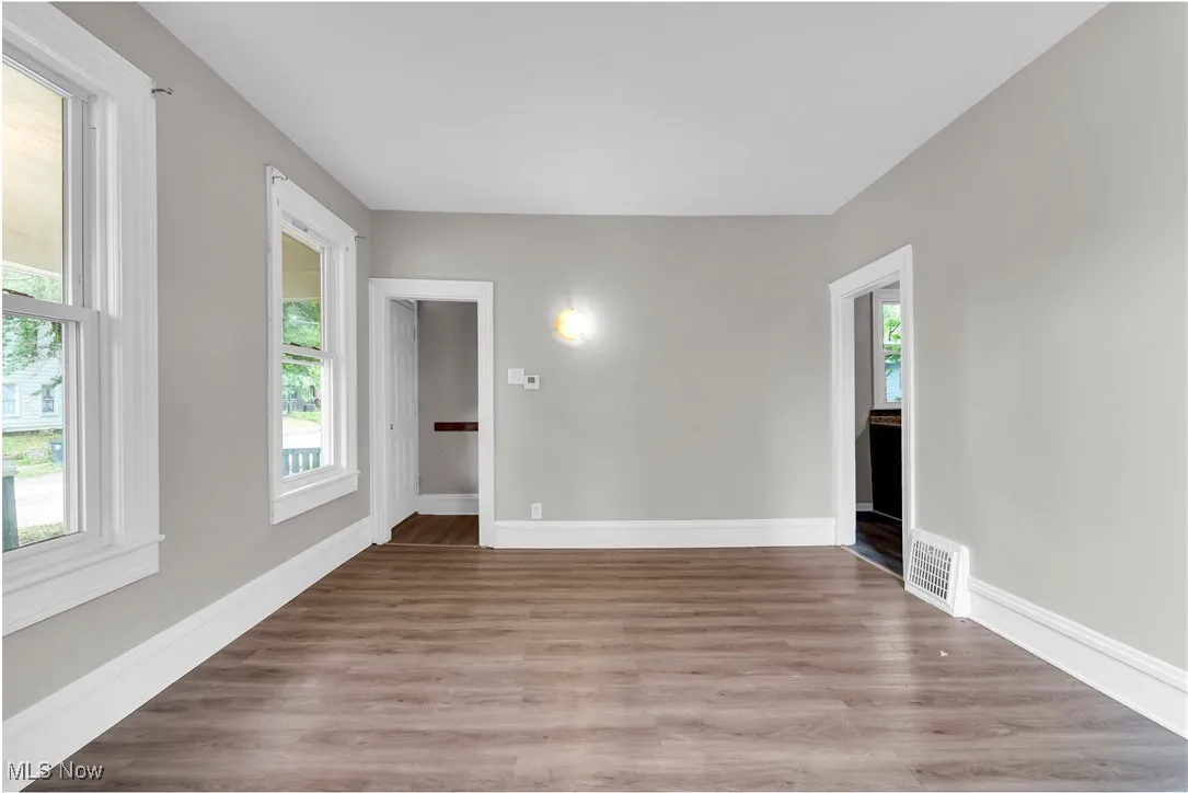 Empty room with light wood finished floors and baseboards