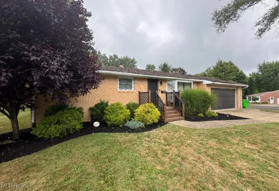 Brick Ranch with landscaped front yard.