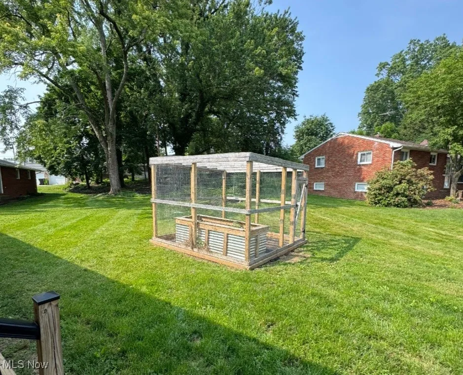 Back yard with enclosed, raised bed garden.