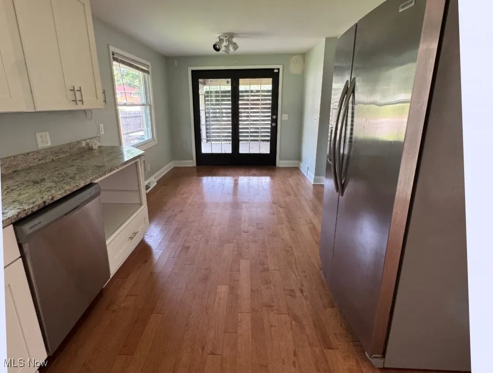 Remodeled Kitchen with Dining Area and doors to patio.