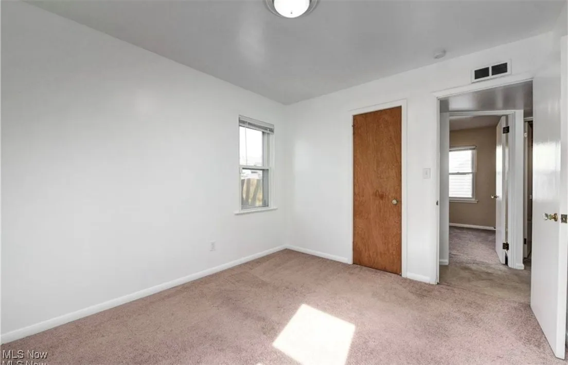 Unfurnished bedroom with carpet flooring and a closet