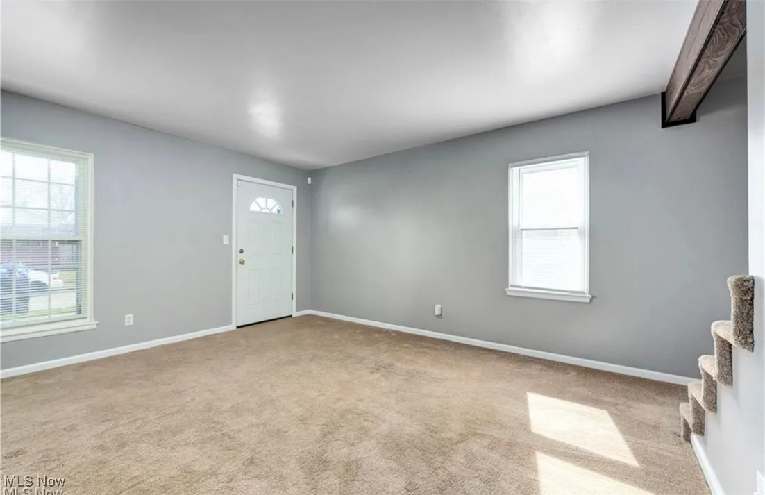 Foyer entrance with light carpet