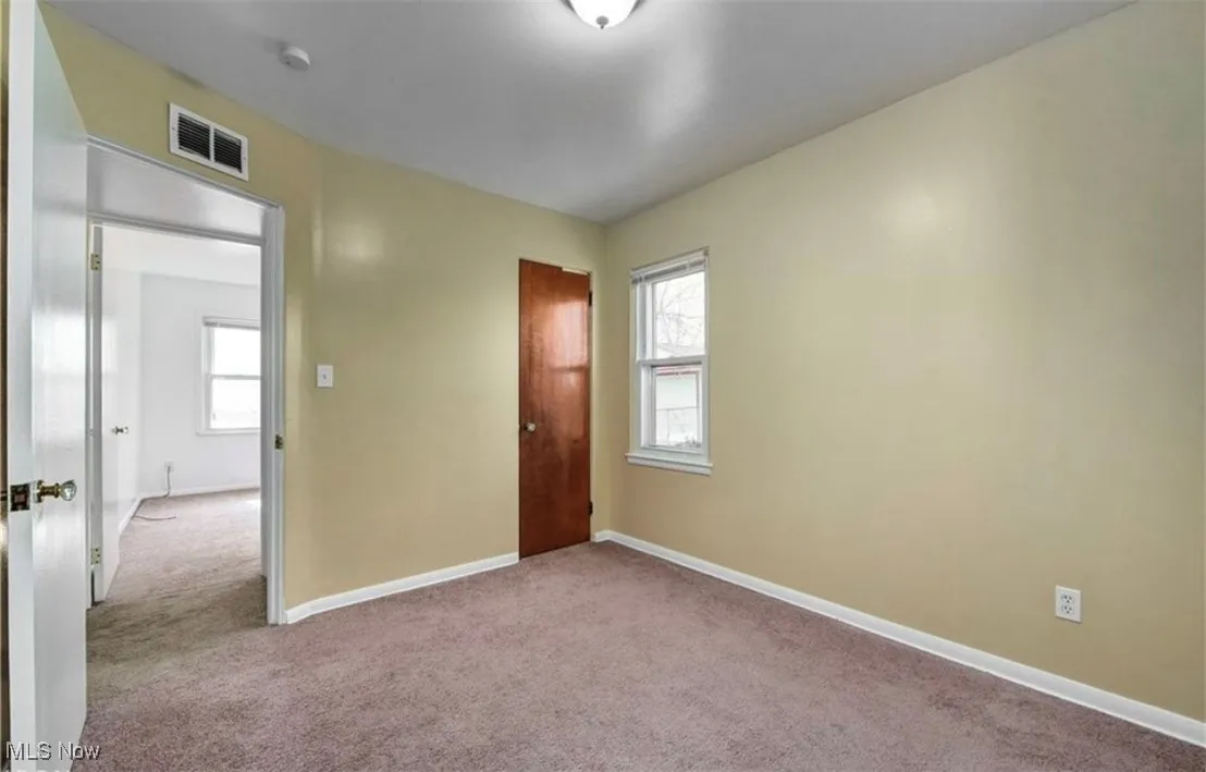 Unfurnished bedroom with carpet flooring and a closet