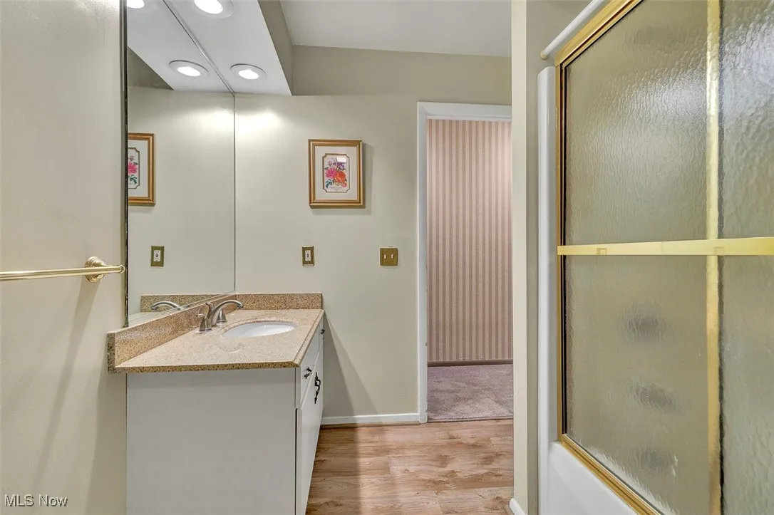 Bathroom featuring vanity, light wood-style flooring, and recessed lighting