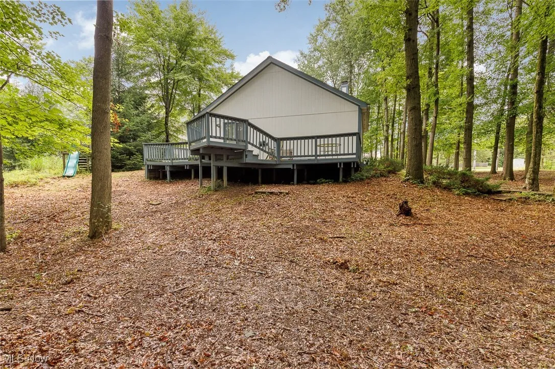 Rear view of property featuring a wooden deck