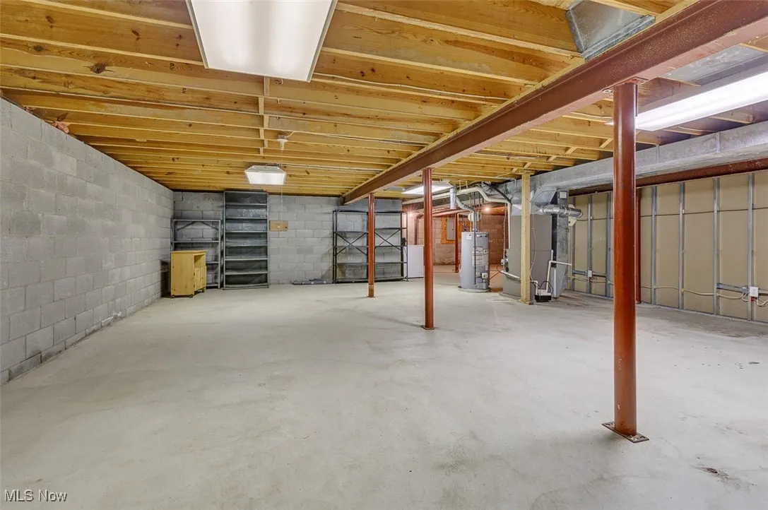 Unfinished basement with heating unit and gas water heater